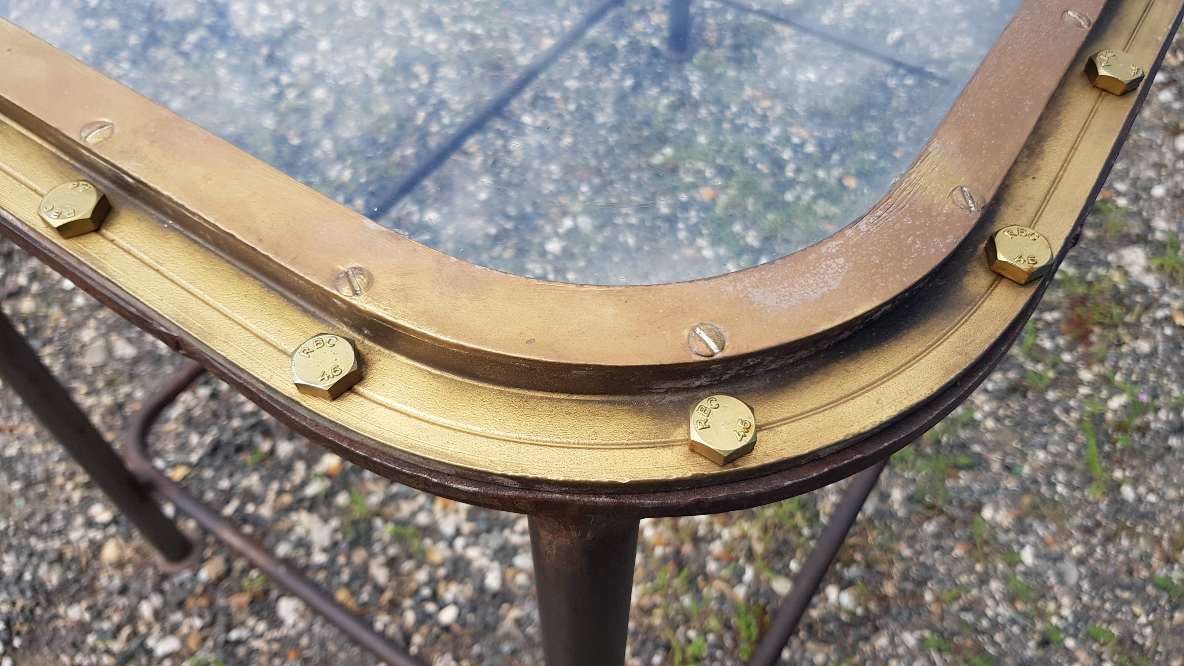 Table with an old ship porthole in brass and a metal base / 110 x 70 x 76 cm