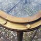 Table with an old ship porthole in brass and a metal base / 110 x 70 x 76 cm