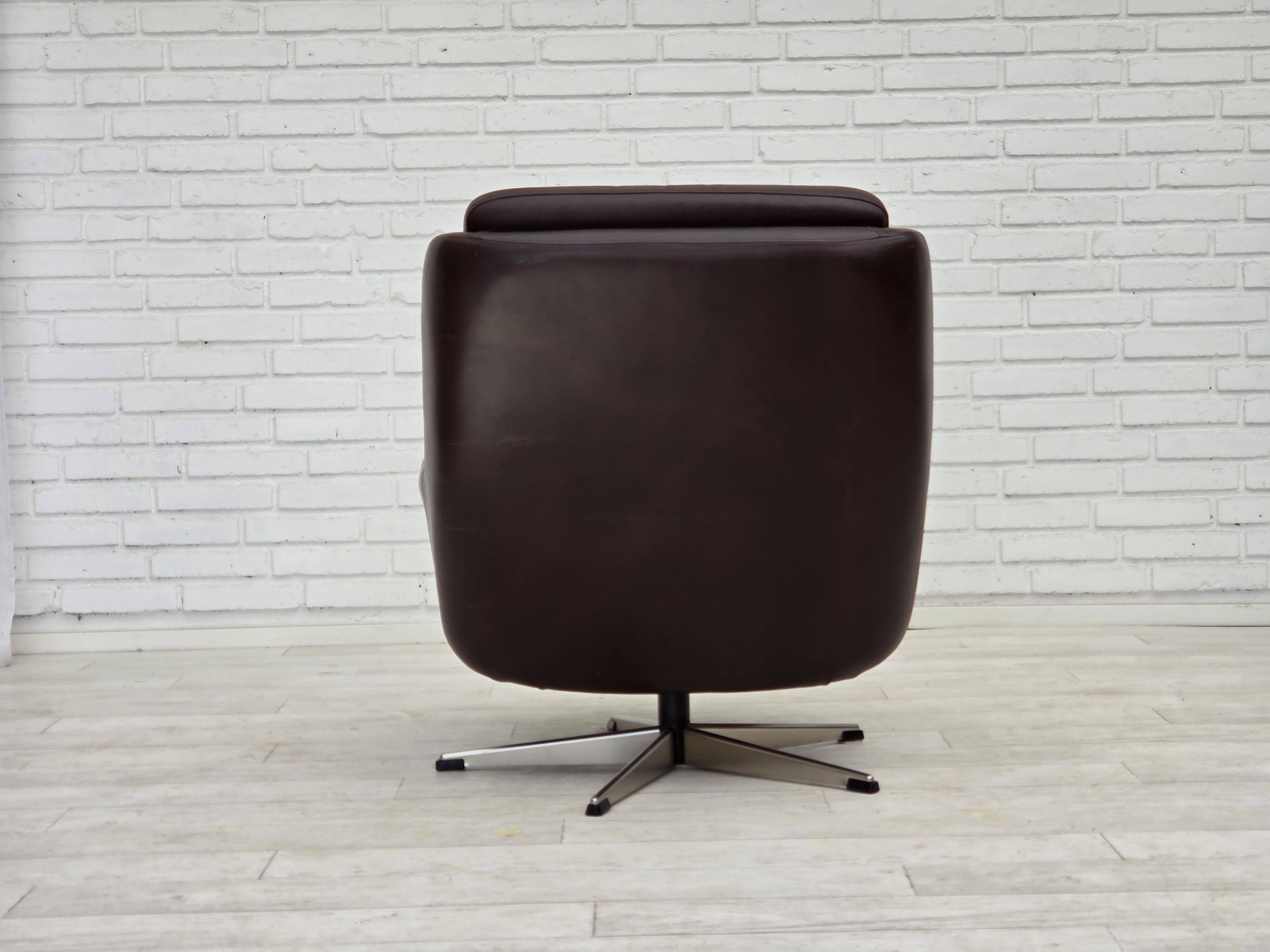 1970s, set of two swivel lounge chairs with footstool, leather.