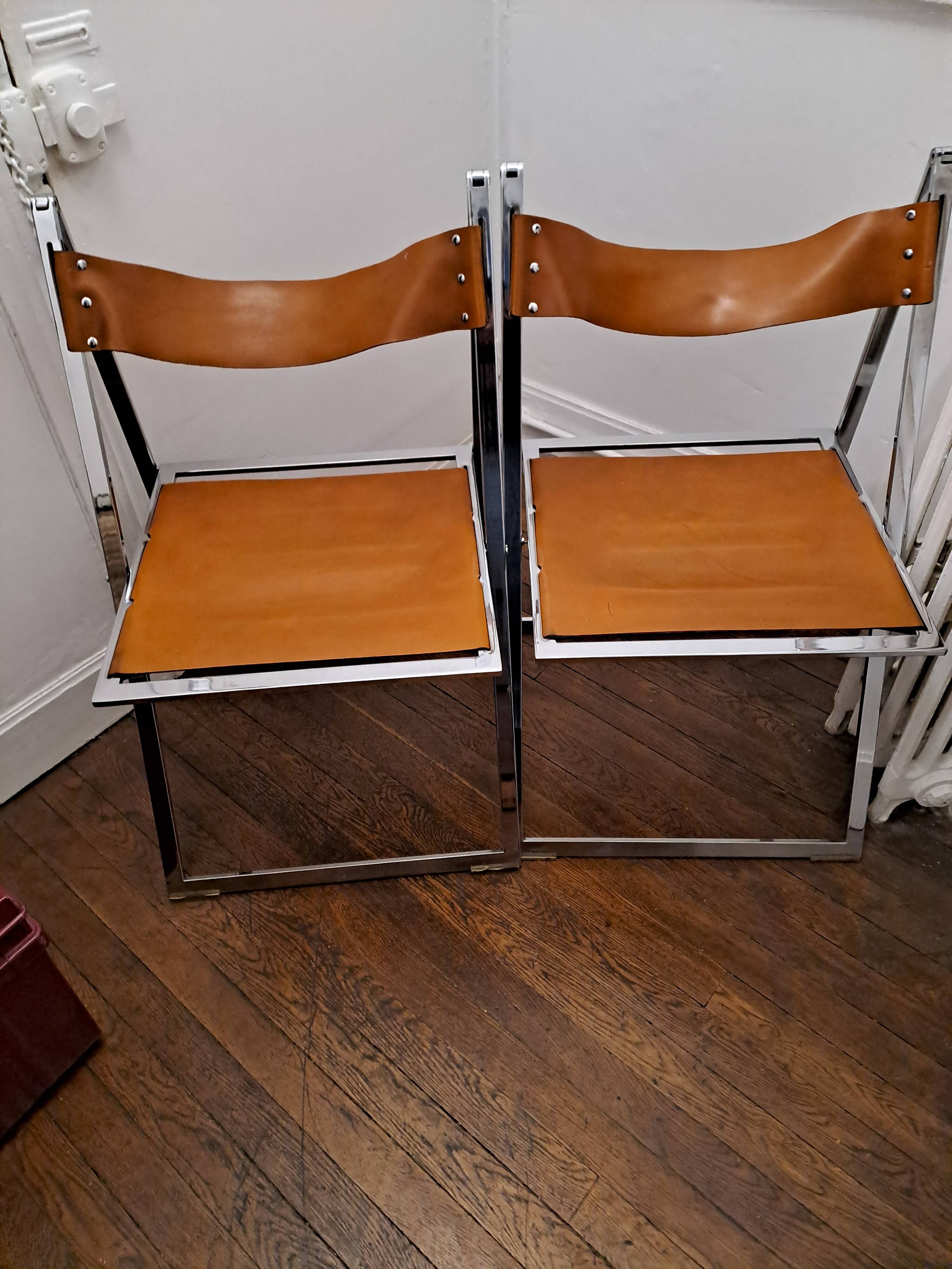 2 Chromed metal and leather folding chairs. 70s. Fontoni & Geraci