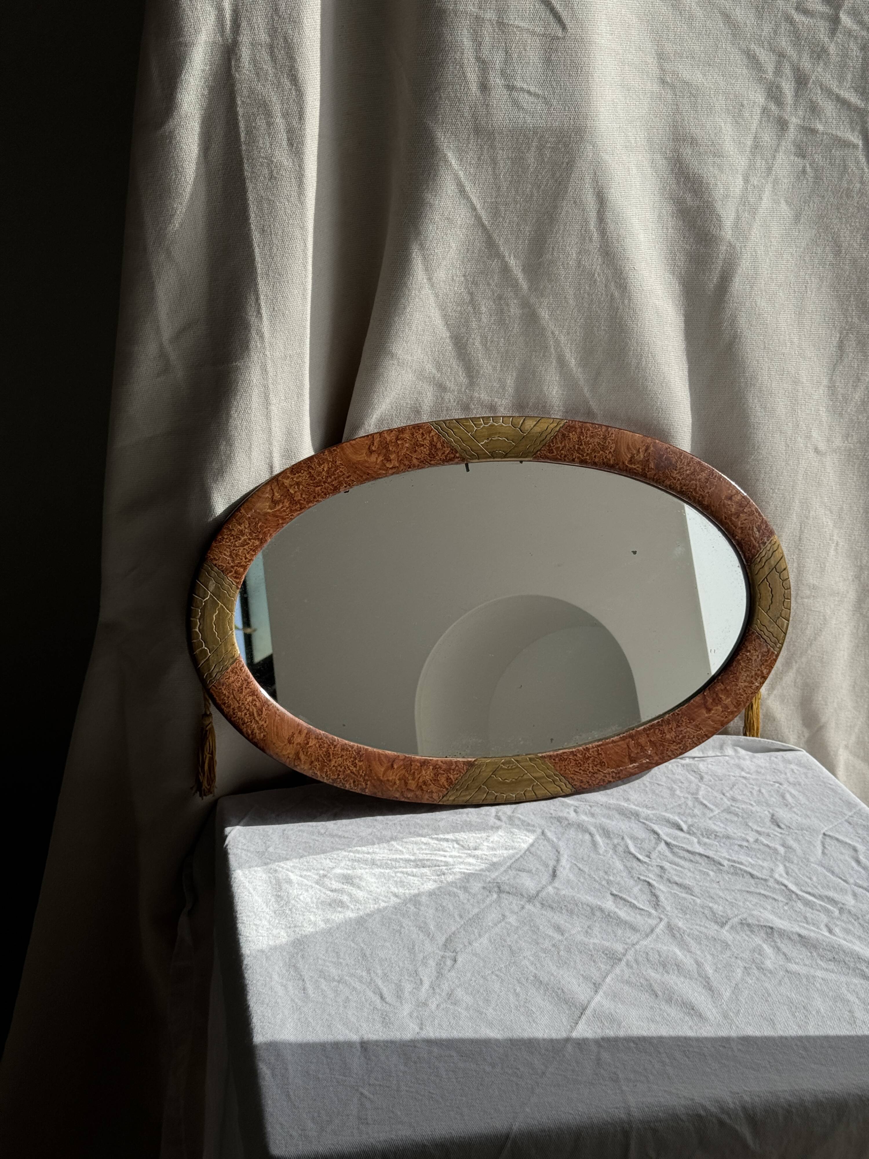 Small oval Art Deco mirror in brown and gold 33x54.