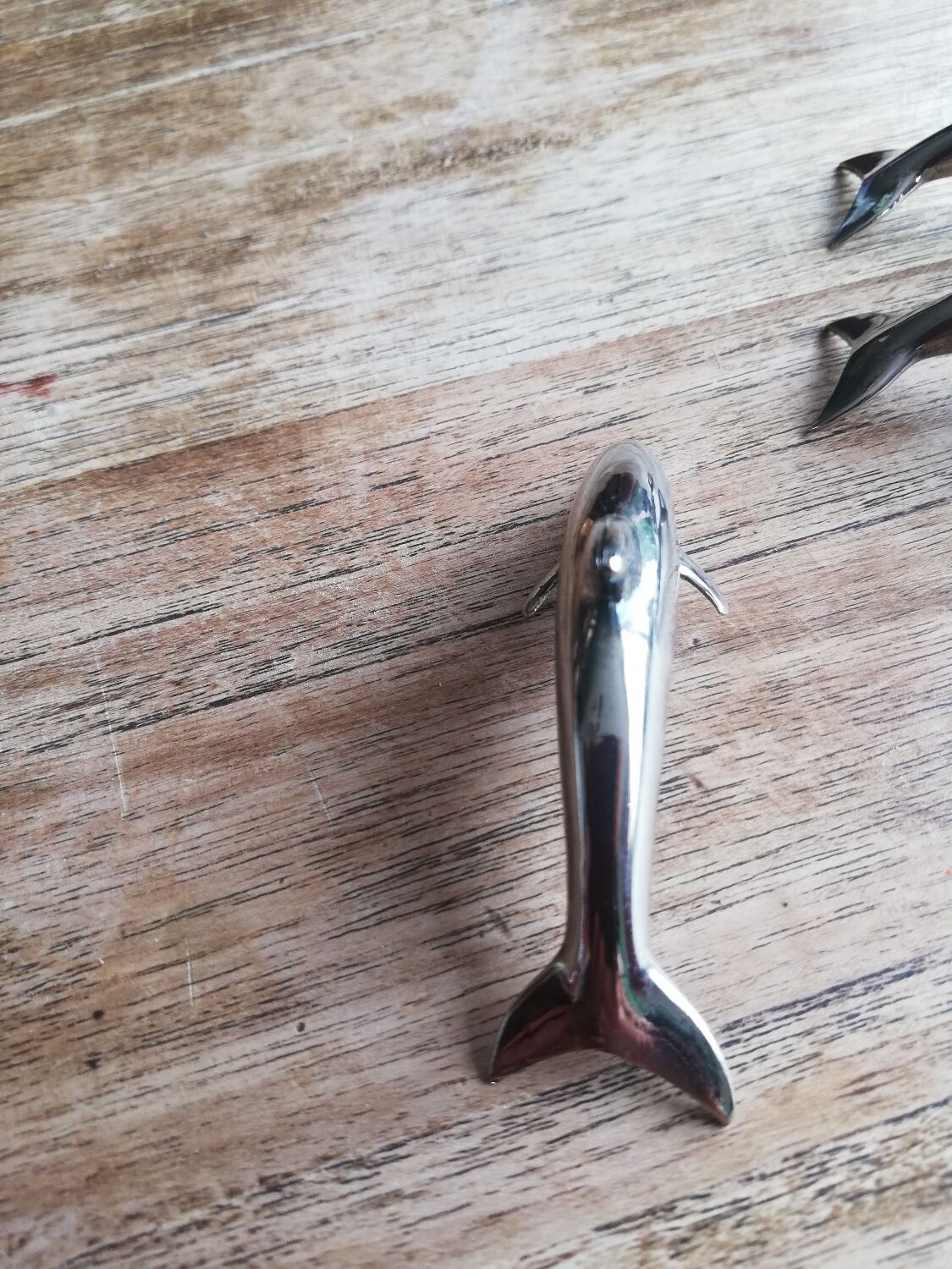 Set of three silver metal dolphin place markers