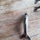 Set of three silver metal dolphin place markers