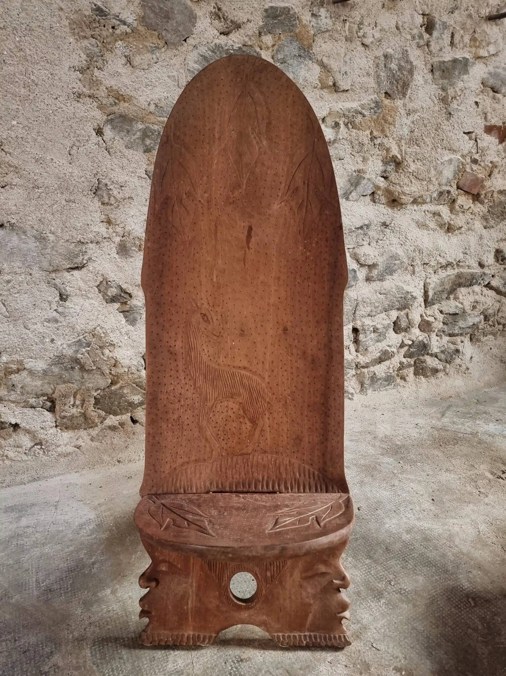 Pair of hand-carved wooden folding chairs – African origin, animal and face motifs, mid-20th century