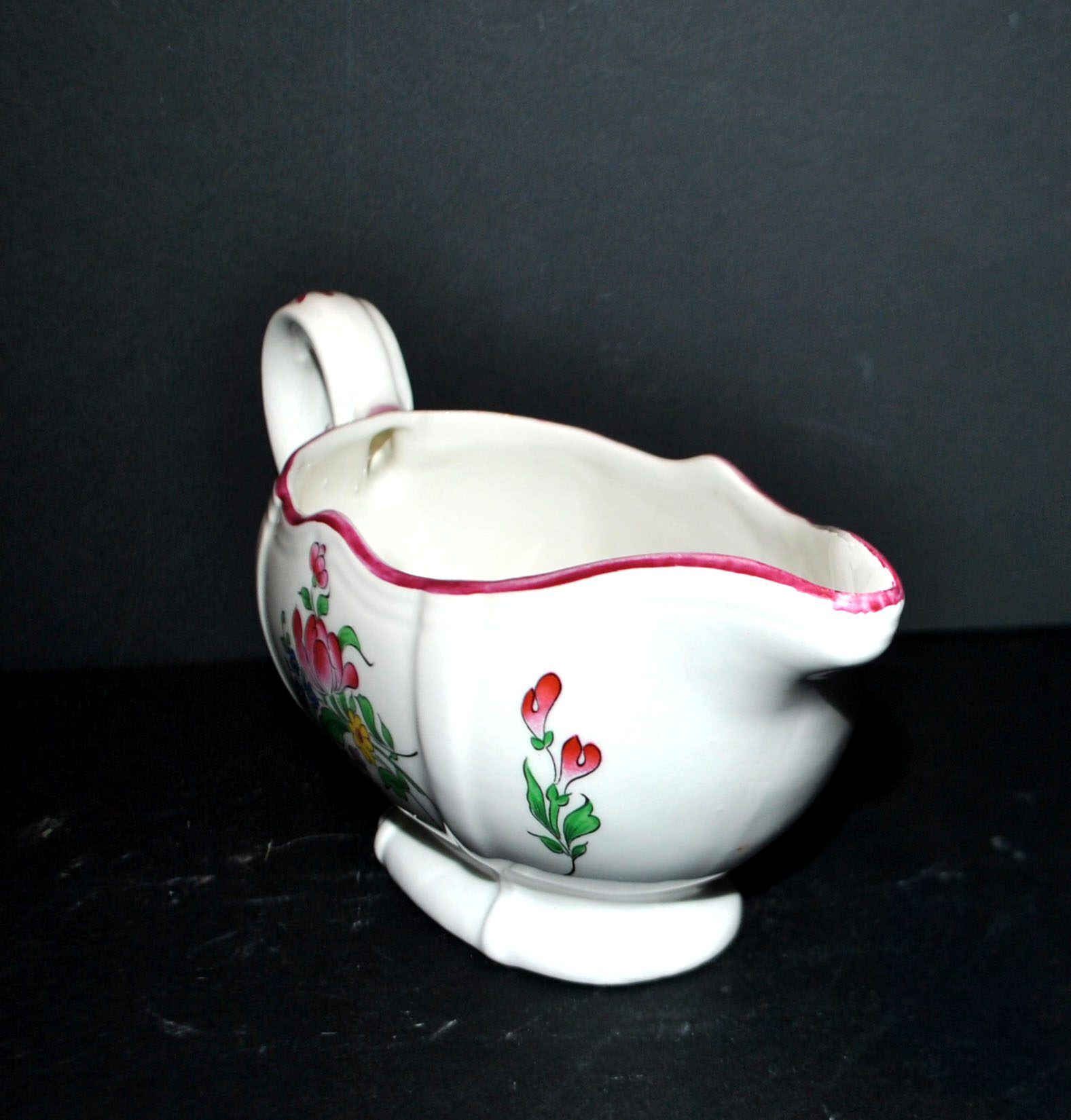 Lunéville KG earthenware sauce boat with polychrome painted flowers, revolving lamp.