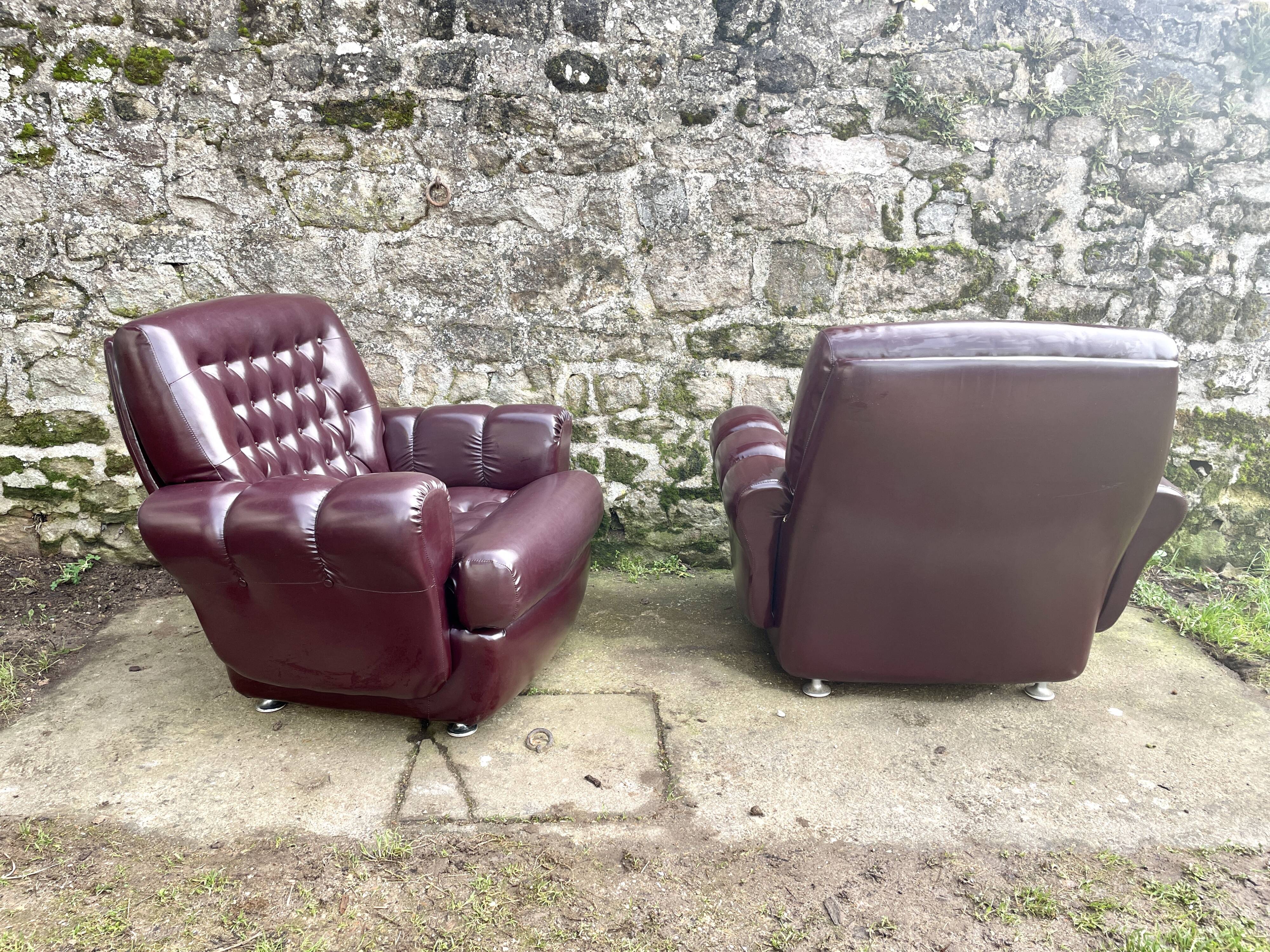 Pair of upholstered armchairs in aubergine imitation leather