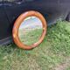 Round varnished wooden mirror