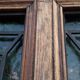 Oak entrance door and its frame and transom, wrought iron gates