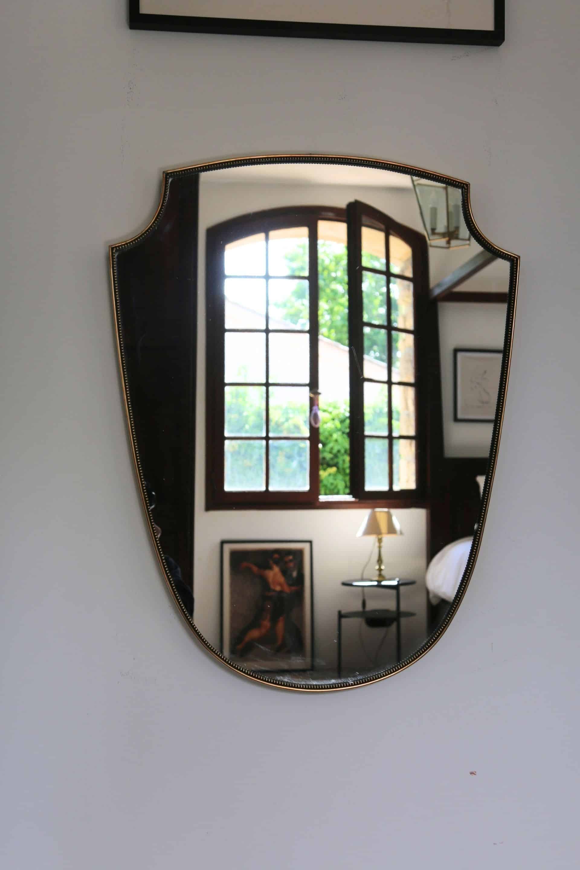 Brass mirror with crest, bead frieze, Italian design style.