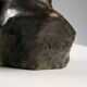 Ancient sculpture of a young woman's face in bronze, 19th-20th century.