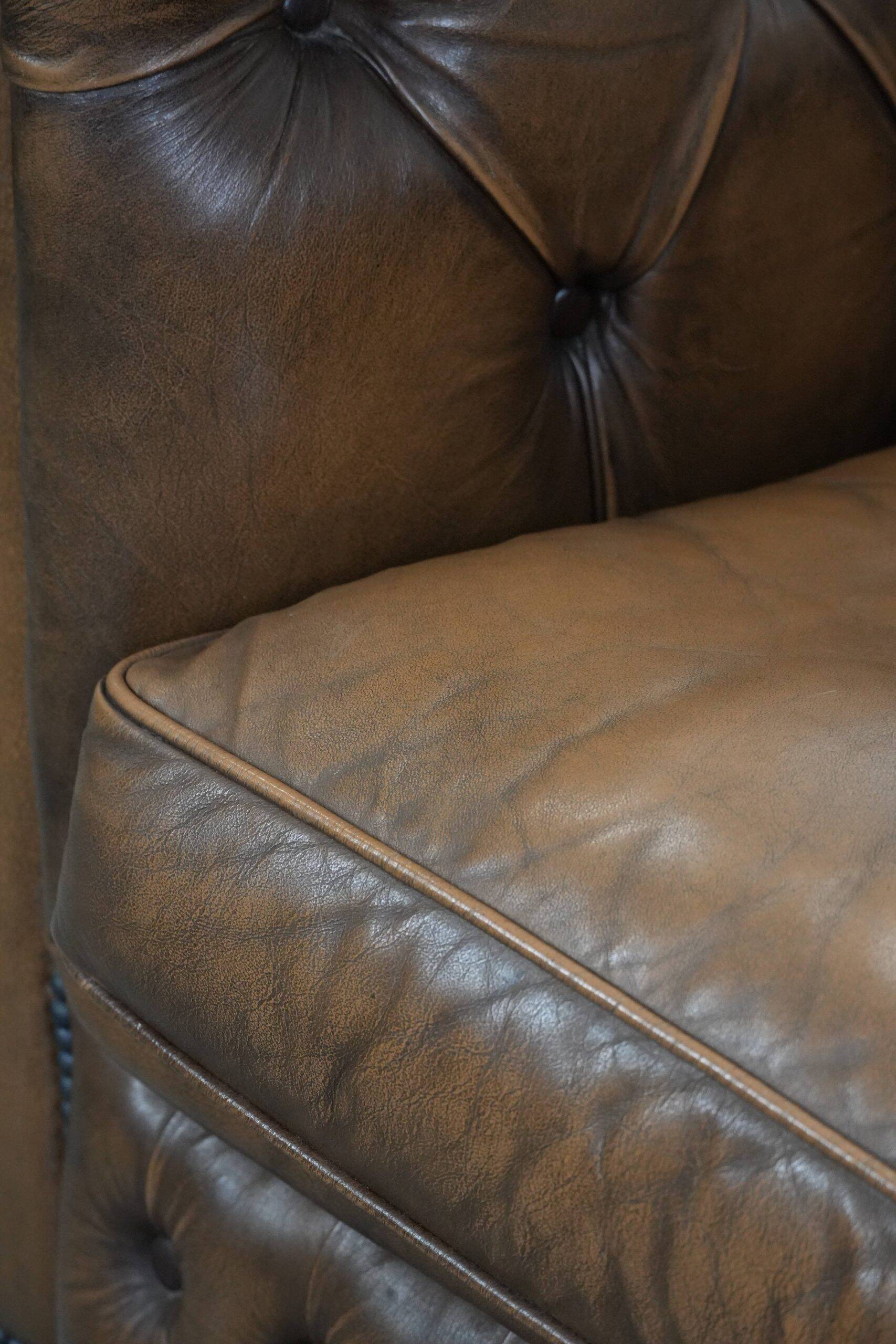 Brown cowhide leather chesterfield armchair  in English style on wheels