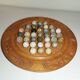 Ancient solitaire game in wood and stone marbles