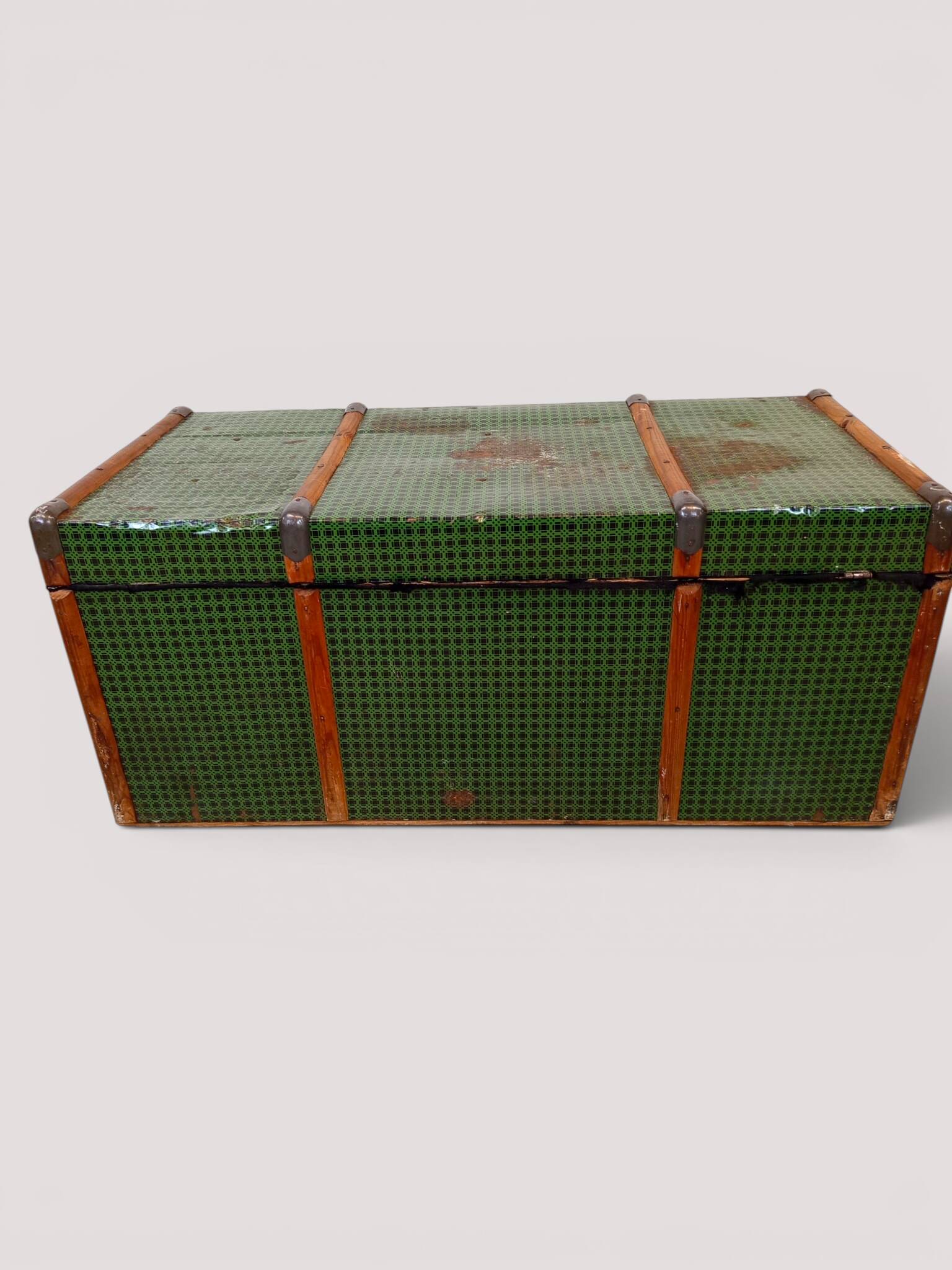 Vintage wooden and metal green travel trunk, circa 1930.