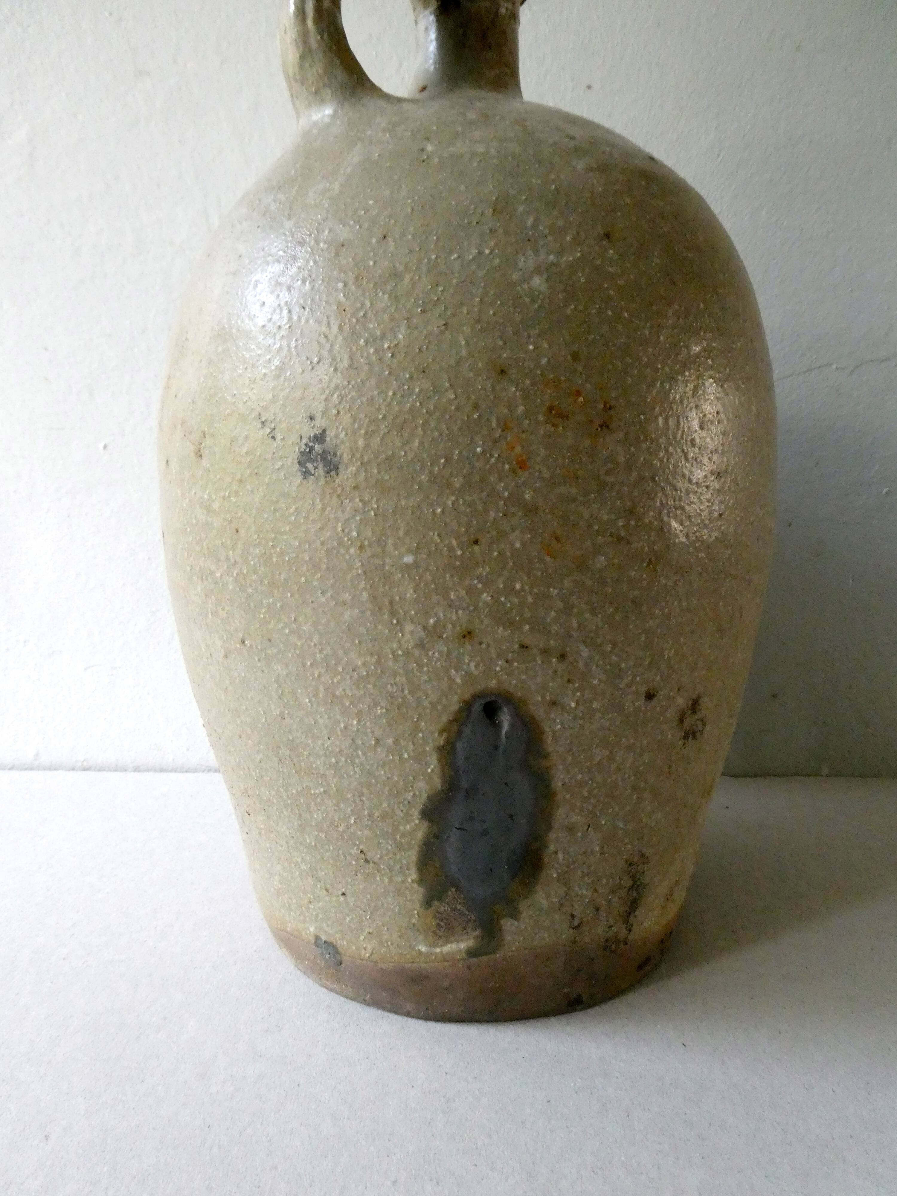 Old bonbonne in glazed stoneware