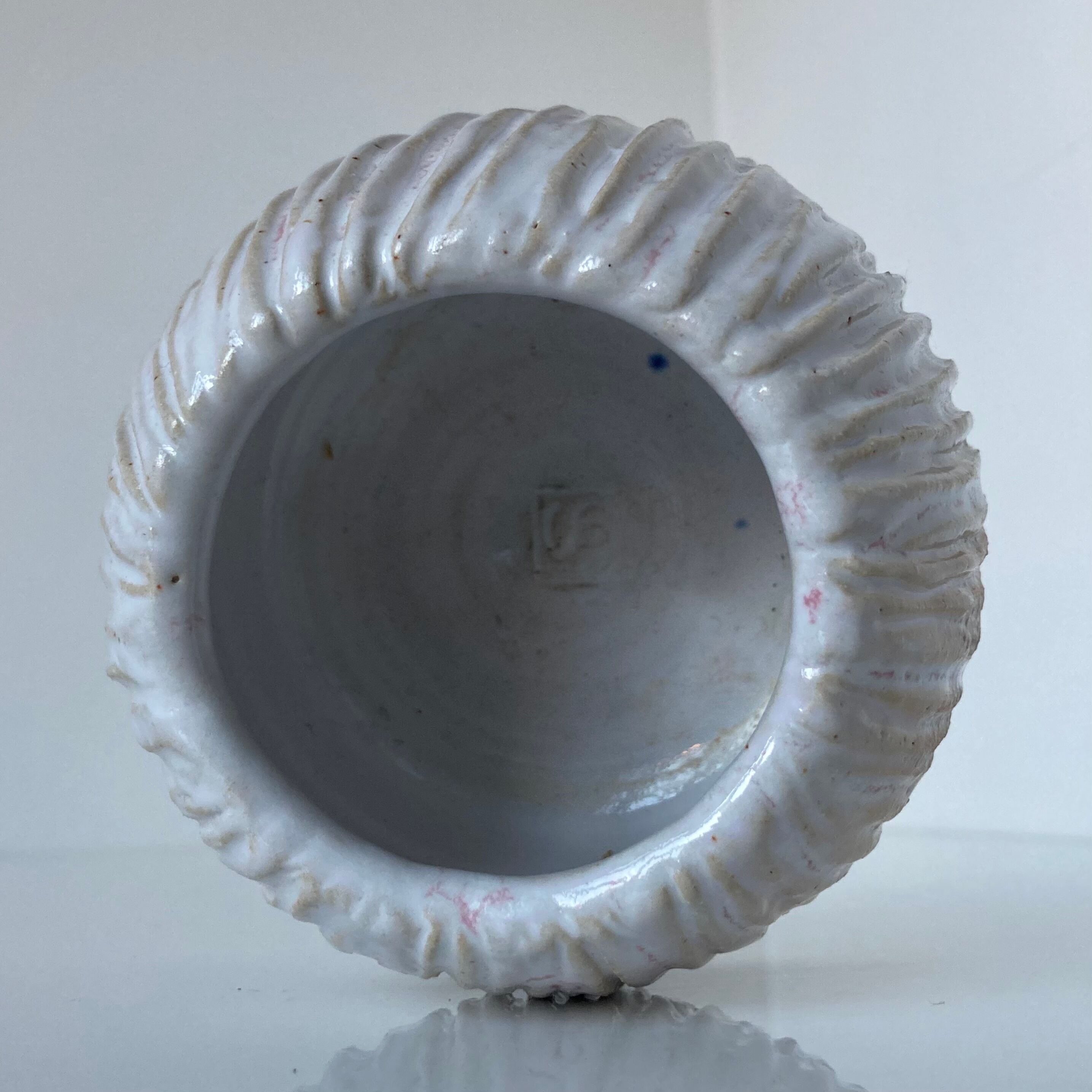 Meeting of three artist's ceramic objects including two pots and a cream covered bowl