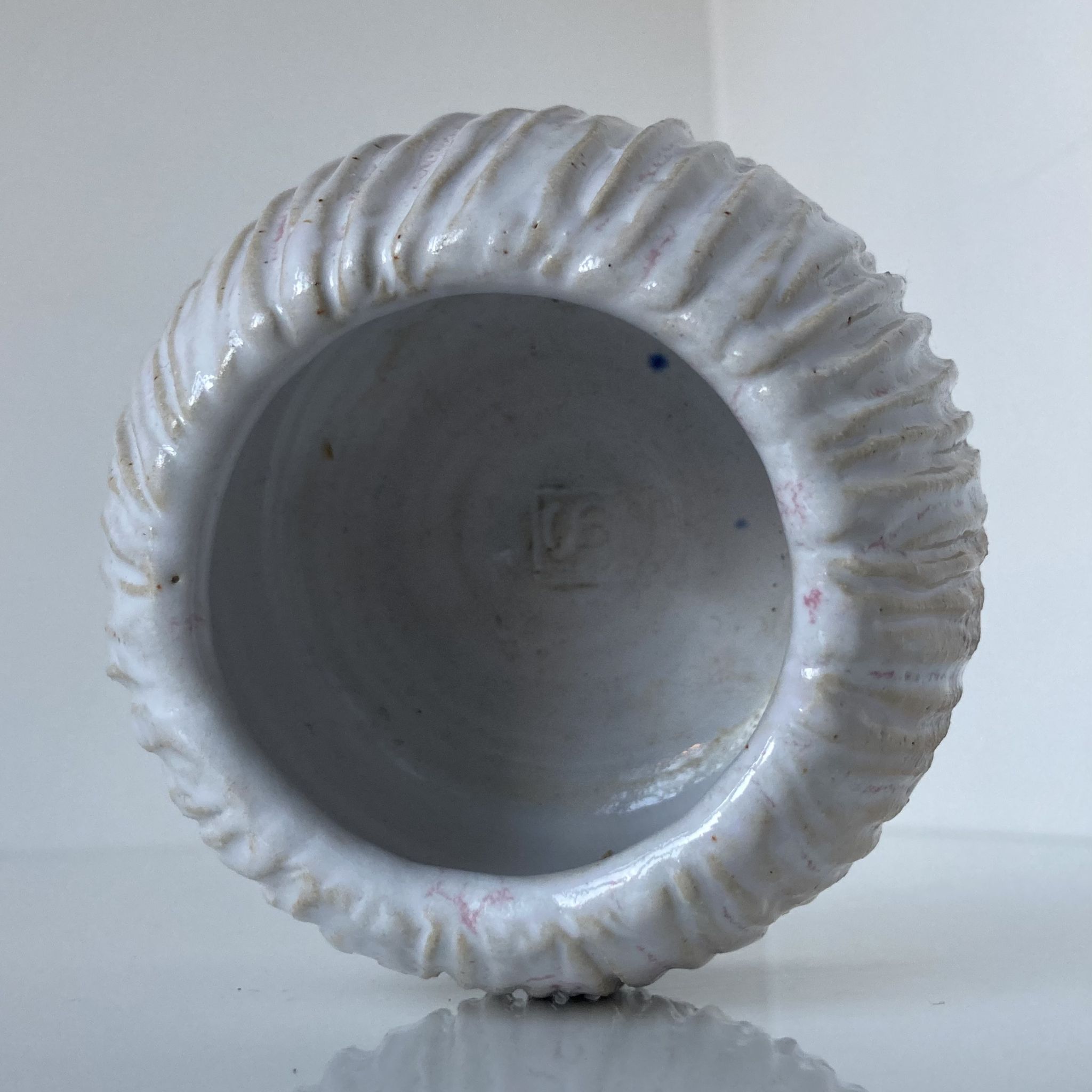 Meeting of three artist's ceramic objects including two pots and a cream covered bowl