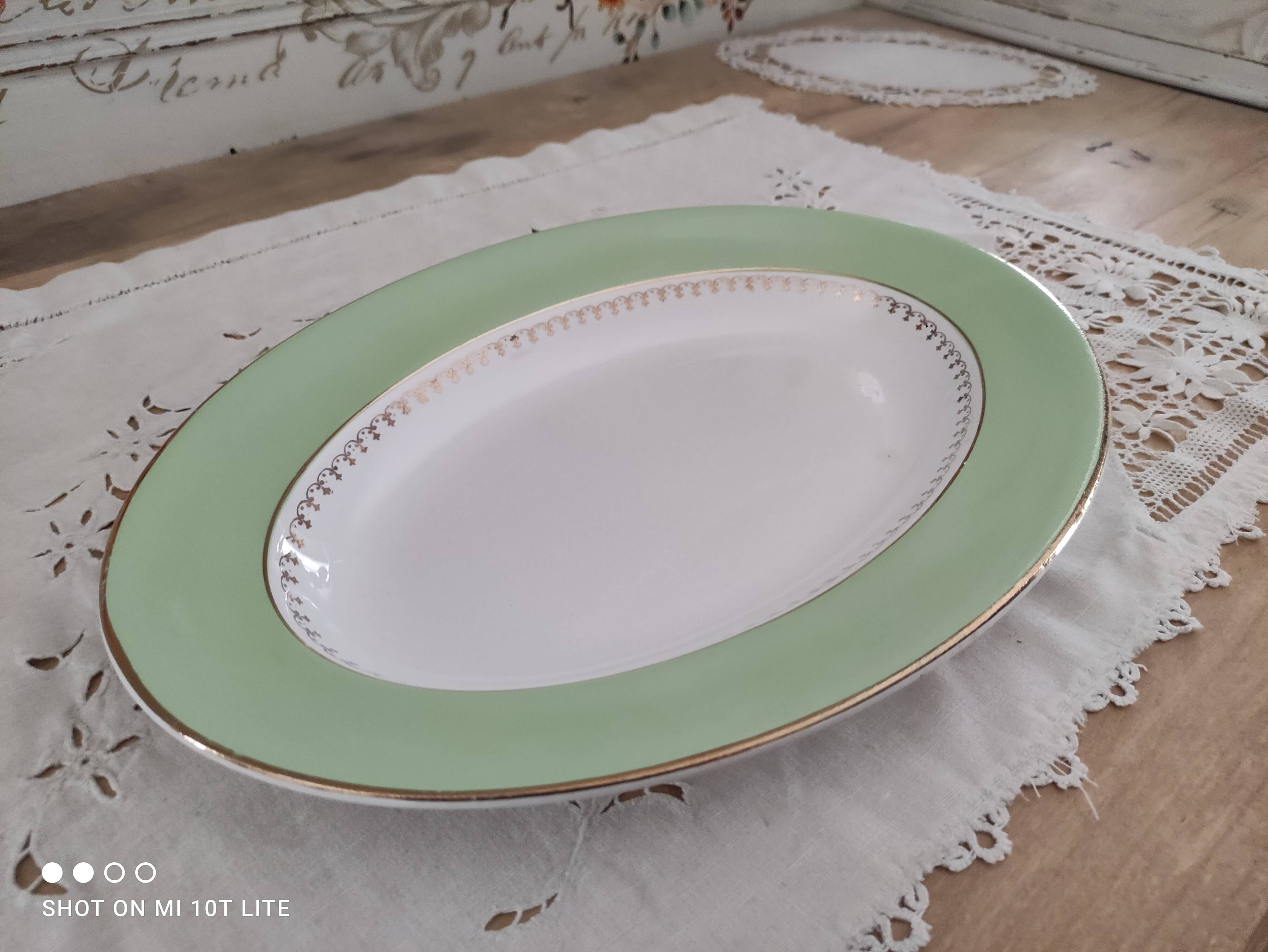 Oval plate with a light green rim and golden frieze, Cafés Lemaire.