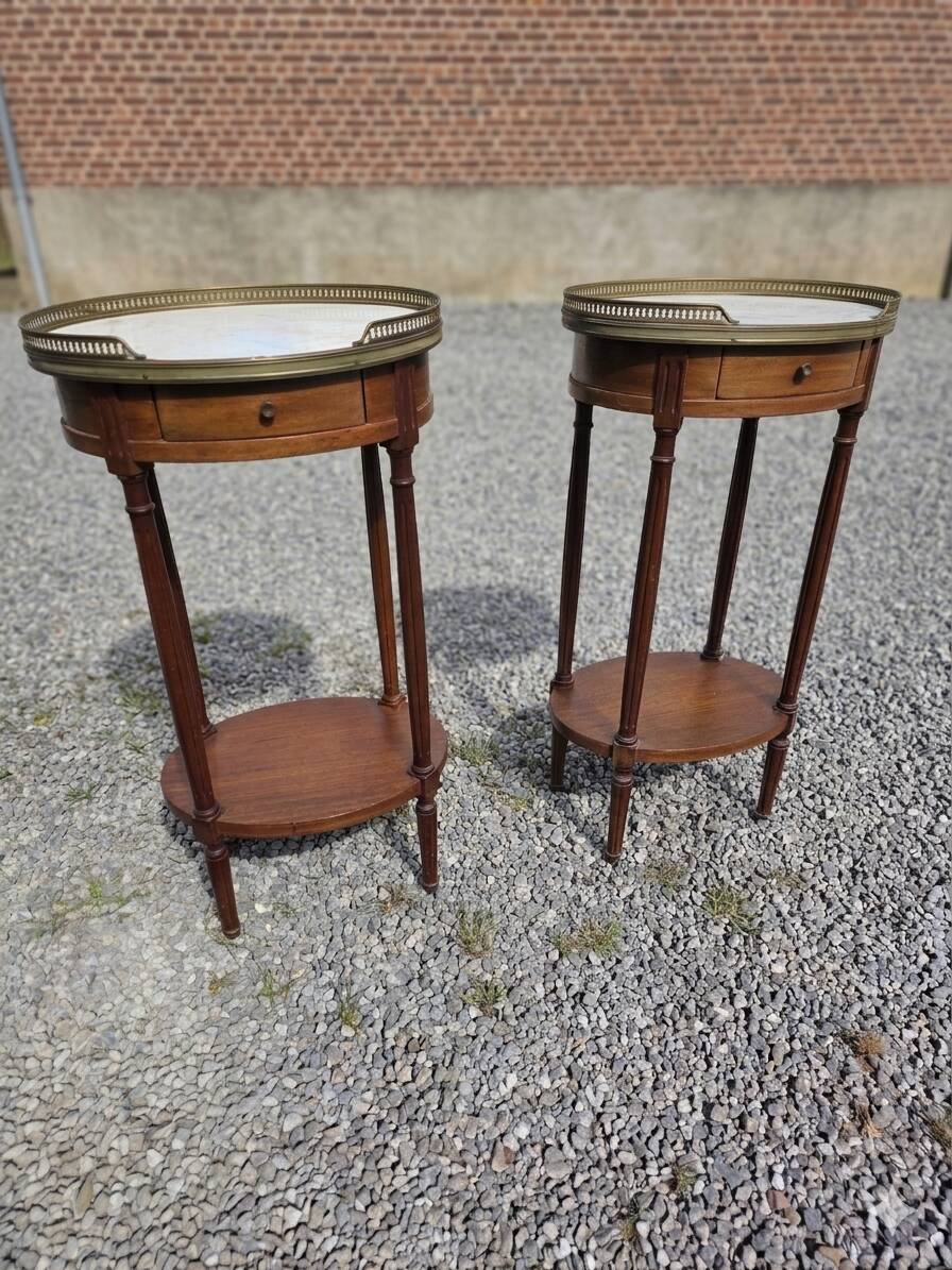 Pair of Louis XVI style bedside tables in mahogany, with marble tops.