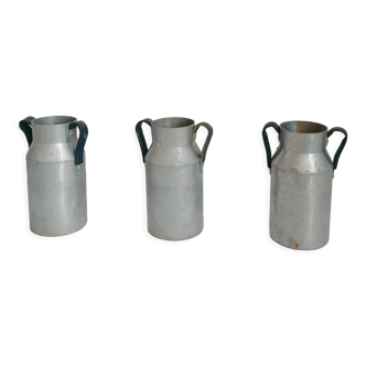 Set of three aluminum milk jugs