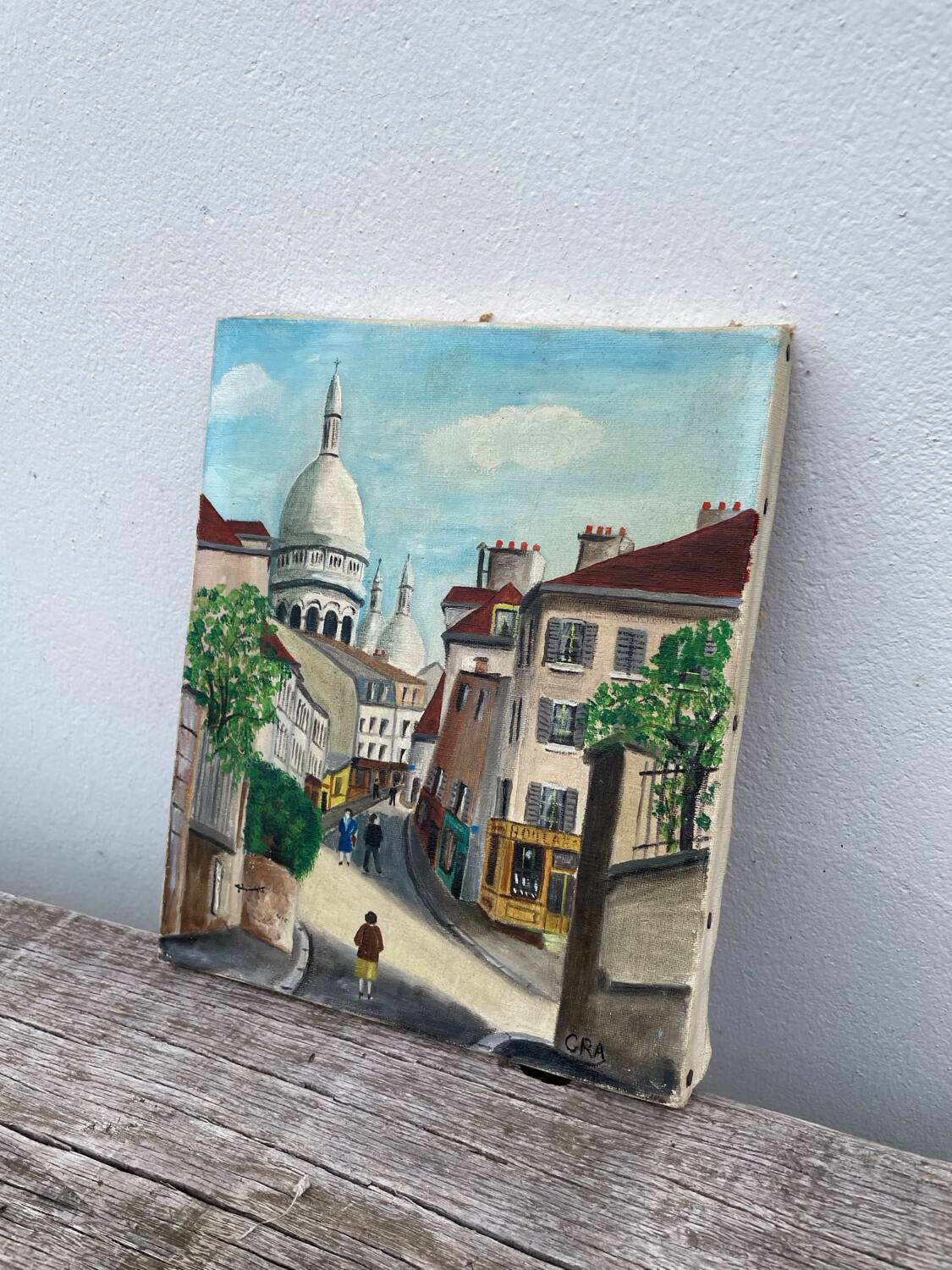 Old oil painting depicting a street in Montmartre