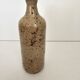 Pyrite stoneware single-flower vase in the shape of a bottle signed Aular?