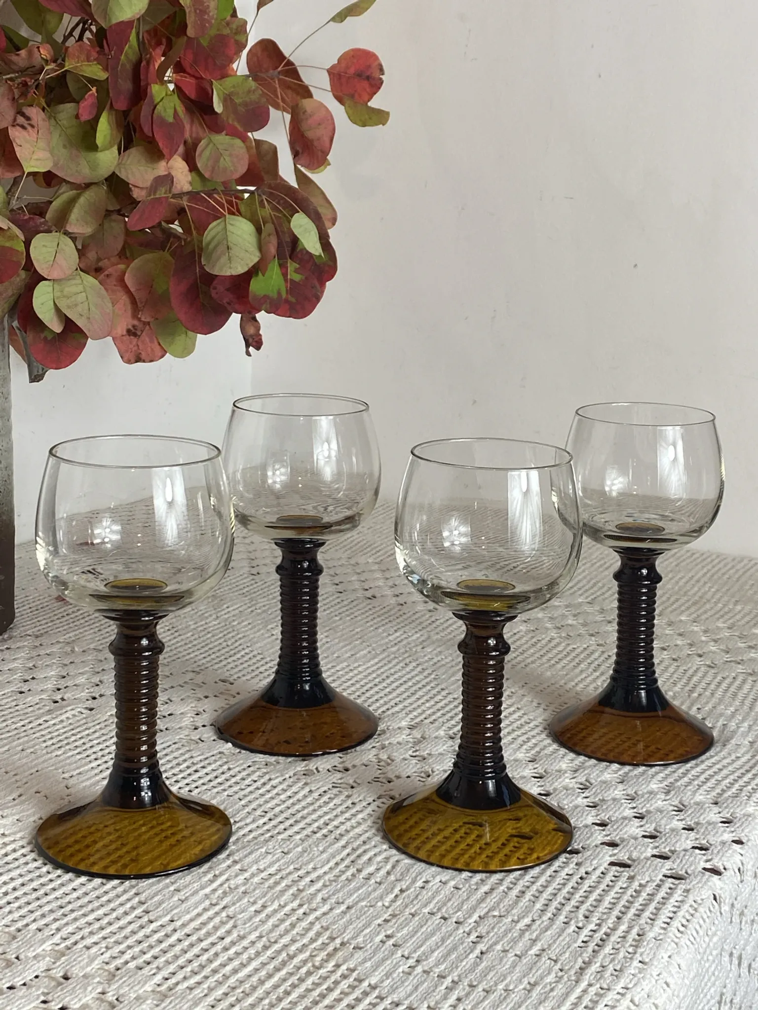 Footed glasses of the Roemer type, amber colour