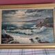 Large old oil painting depicting a seascape.
