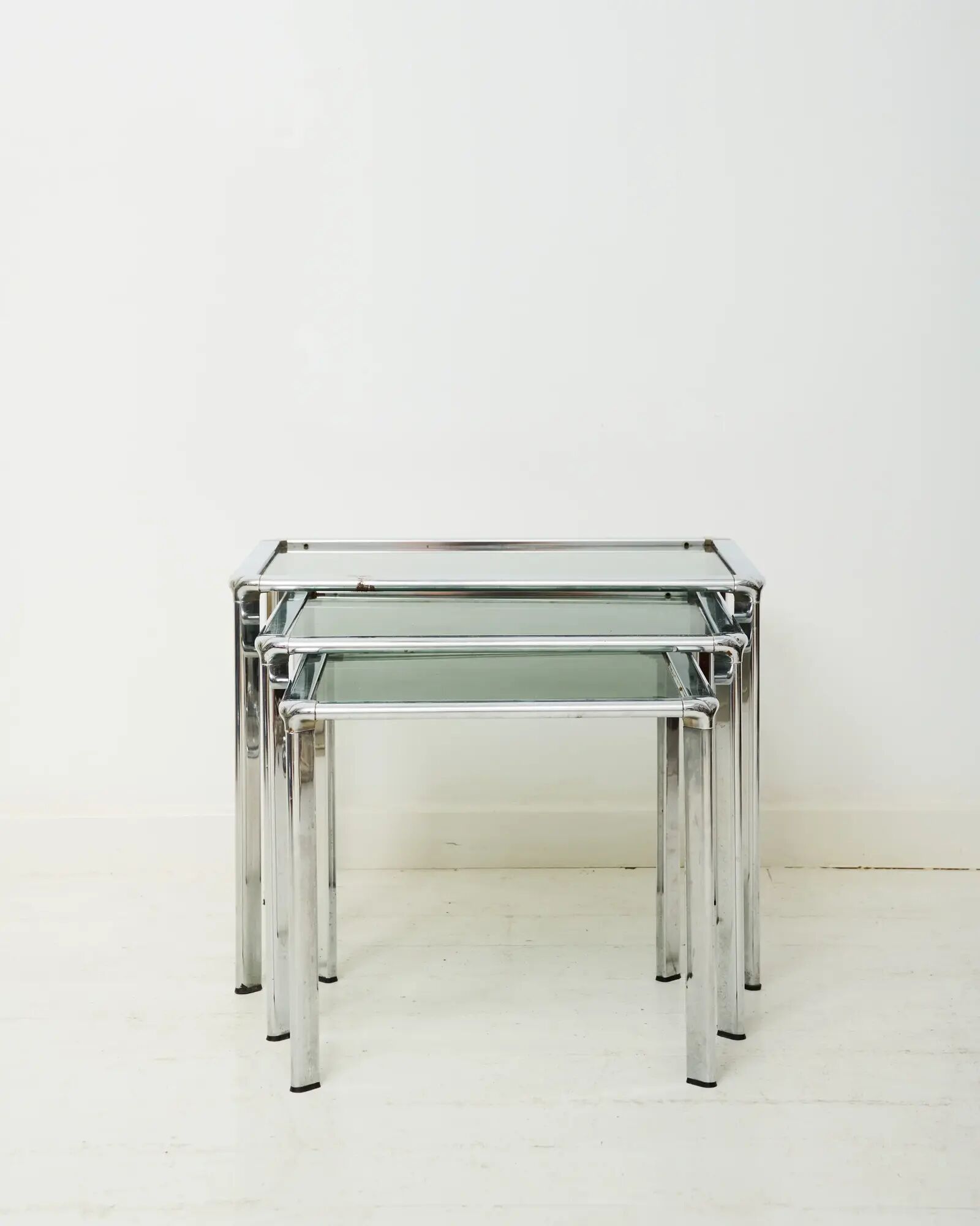 Nest tables in chrome and smoked glass, Italy, 1970s.