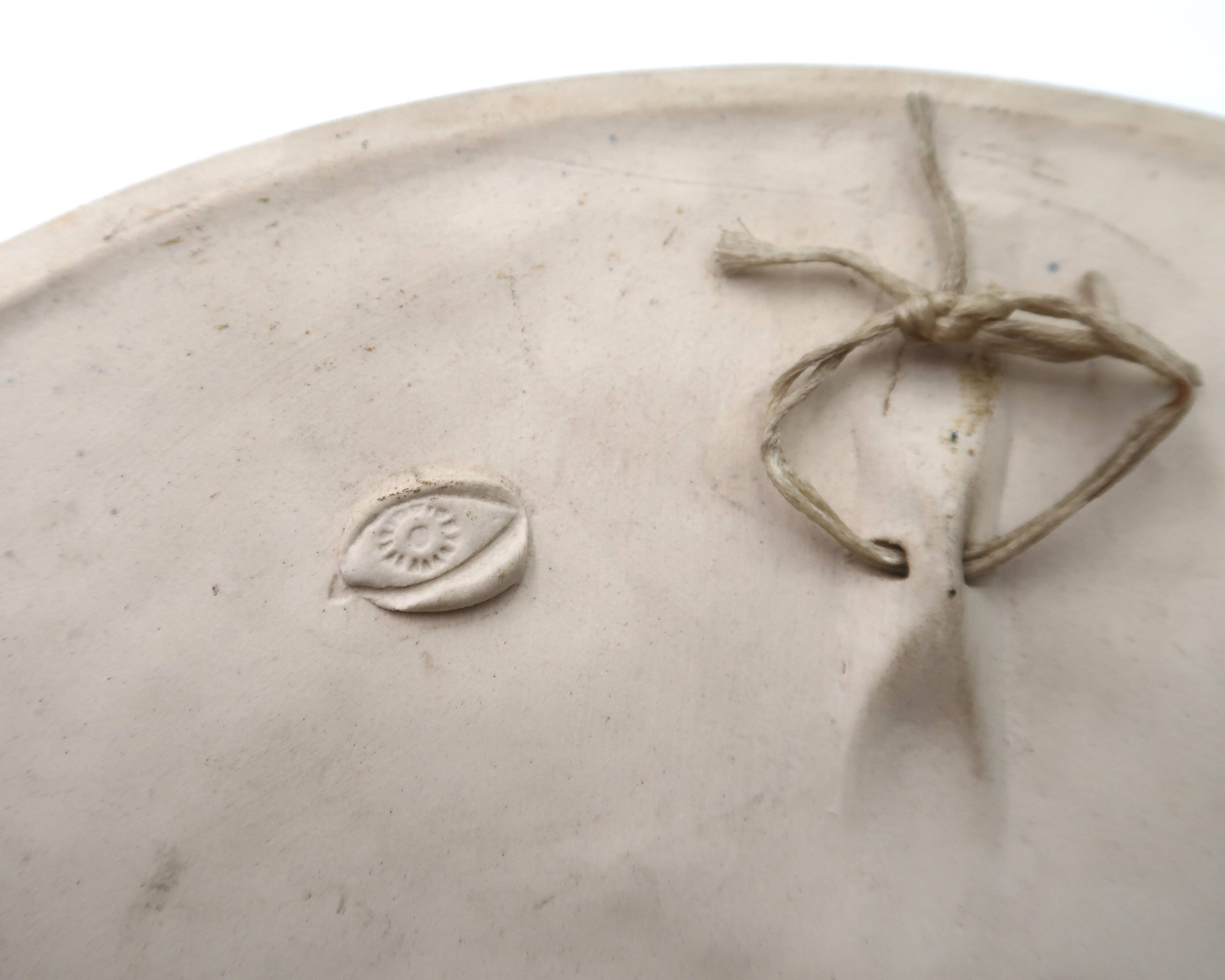 Relief mural signed in ceramic, sun with blue and gold face, 1990s.