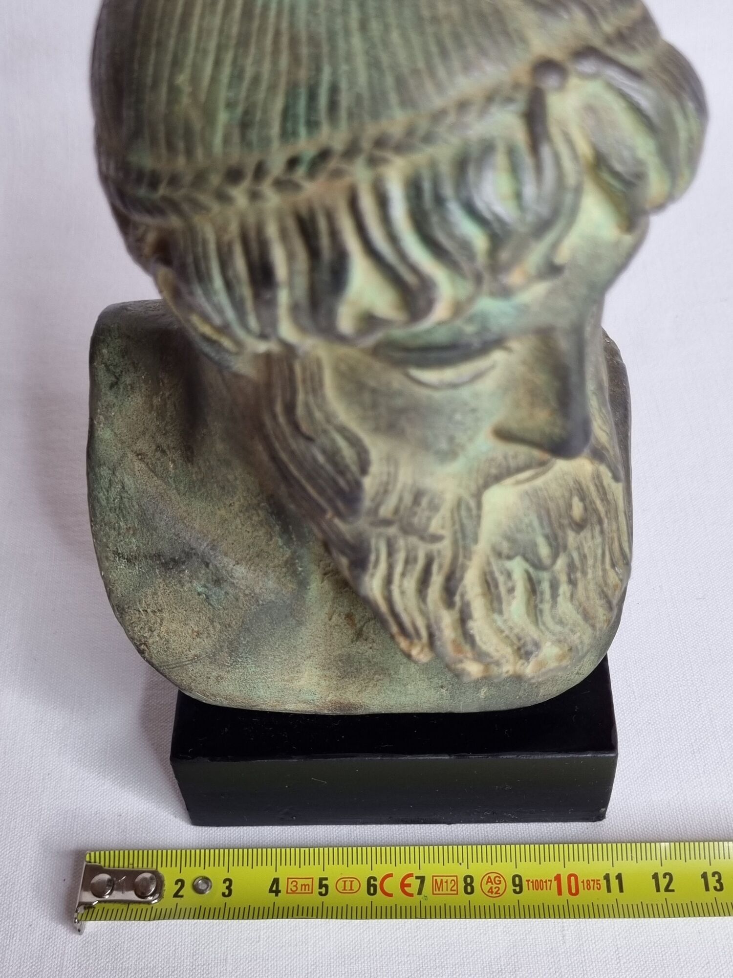 Bust of Poseidon in patinated plaster on wooden base