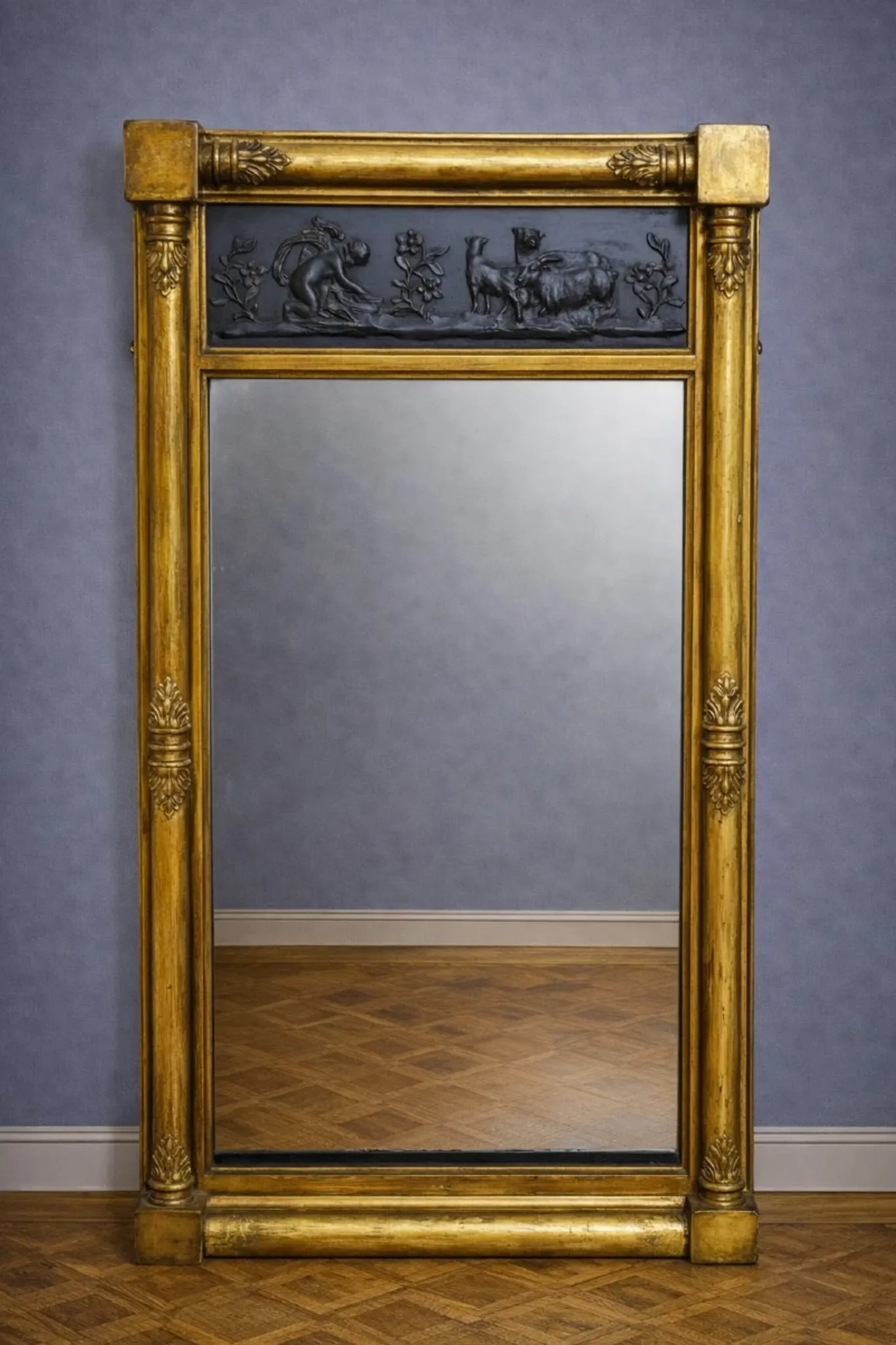 Large antique gilded wooden mirror with terracotta relief from the Empire period.