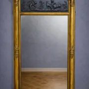 Large antique gilded wooden mirror with terracotta relief from the Empire period.