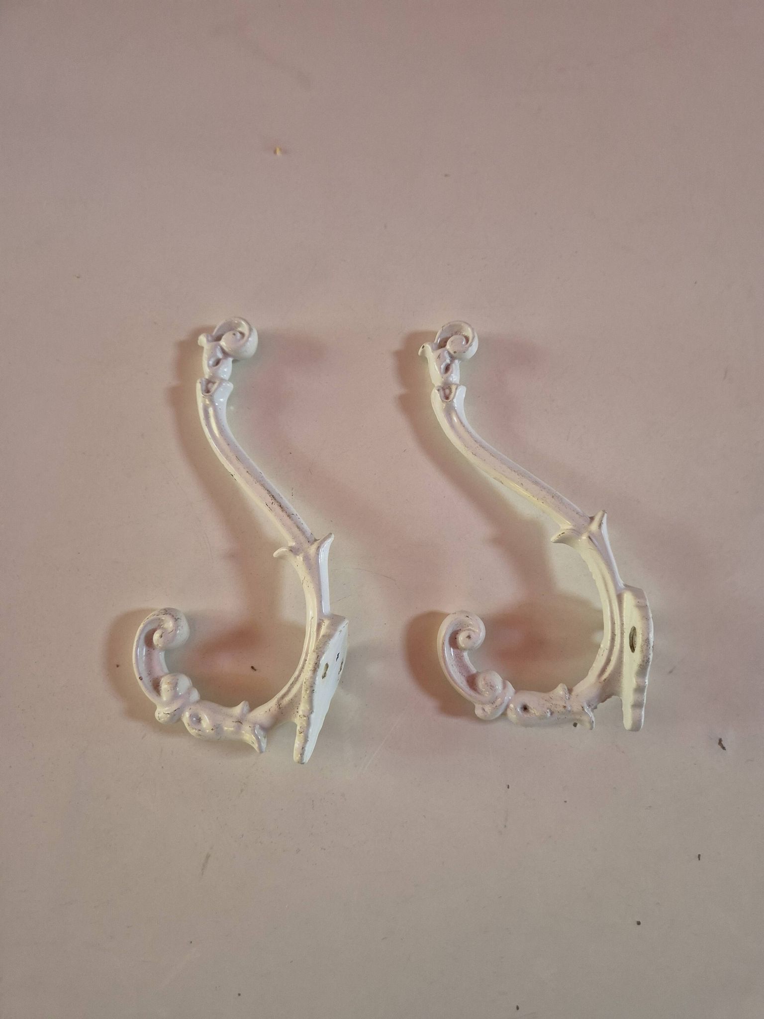 set of 2 vintage white cast iron hooks, small paint chips from the year