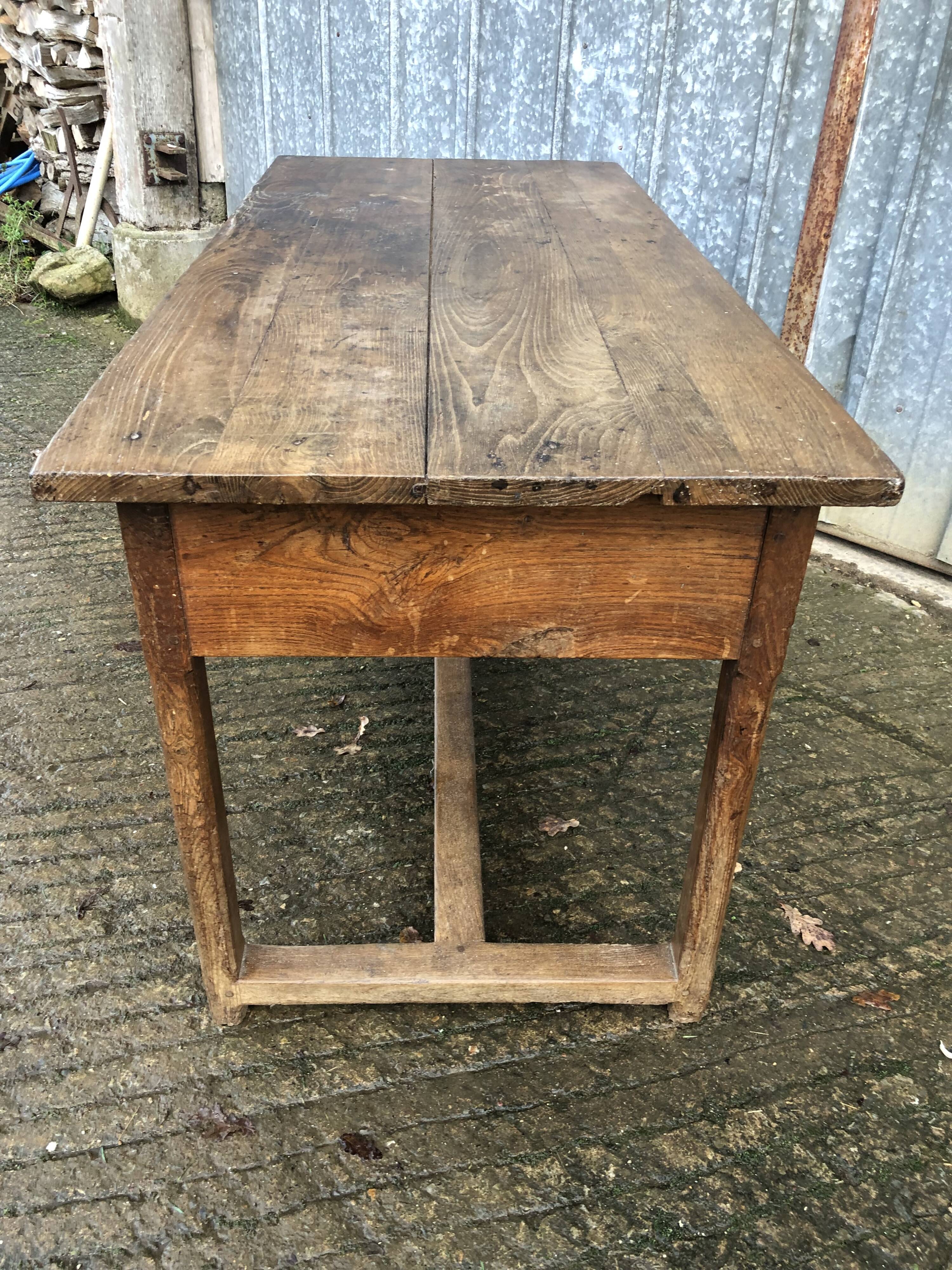 Old chestnut table with 3 front drawers and a cat bar.