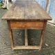 Old chestnut table with 3 front drawers and a cat bar.