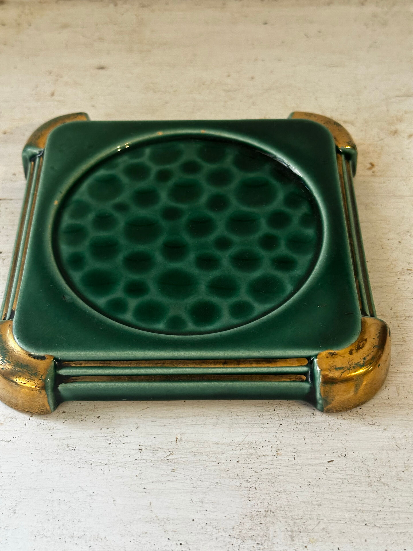 Art Deco bottle coaster in speckled green glazed ceramic and