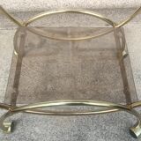 Service console with design / gilded metal wheels and smoked glass