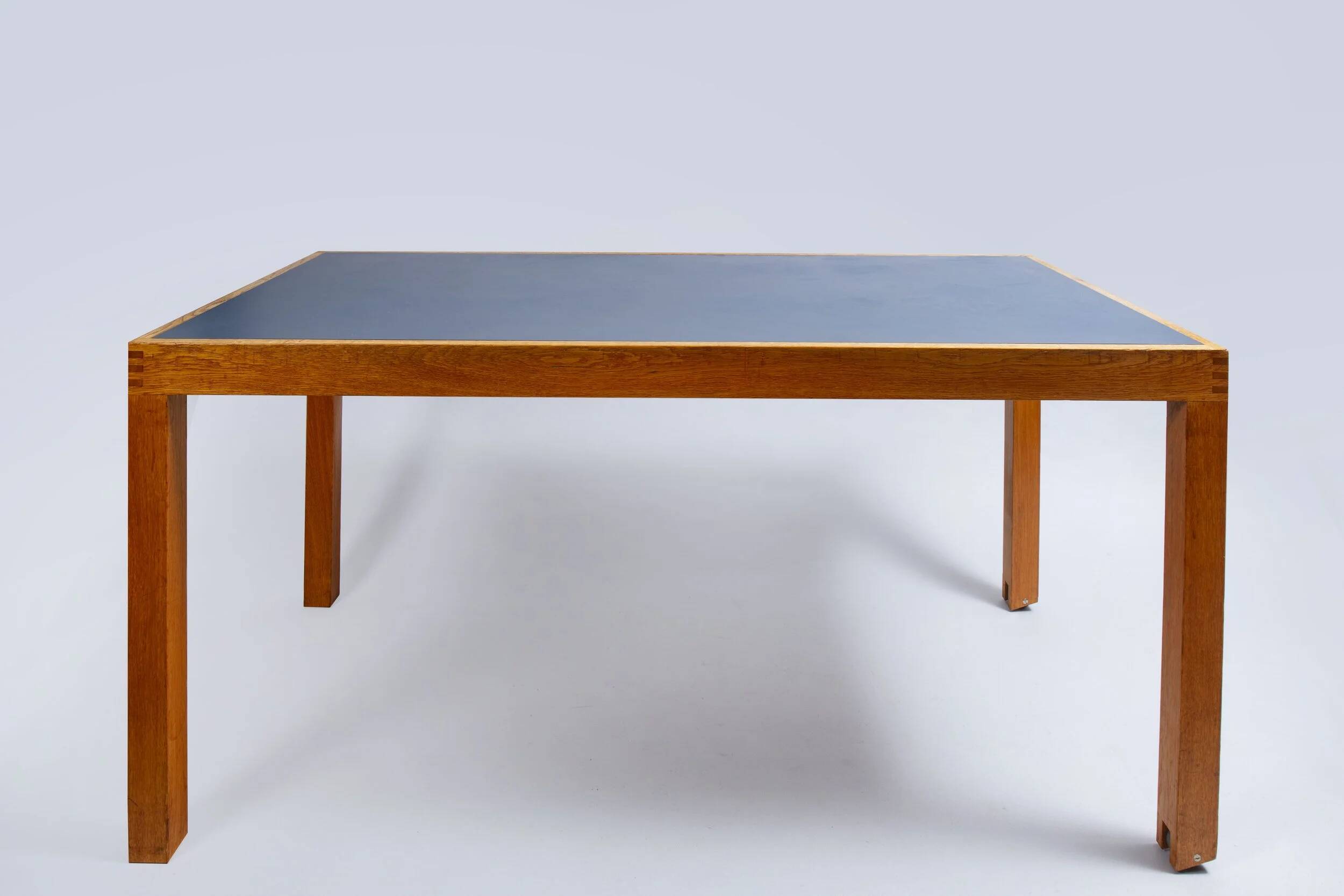 Pine table with a top covered in linoleum.