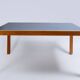Pine table with a top covered in linoleum.