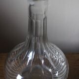 Round-bellied glass carafe with ribbed neck.