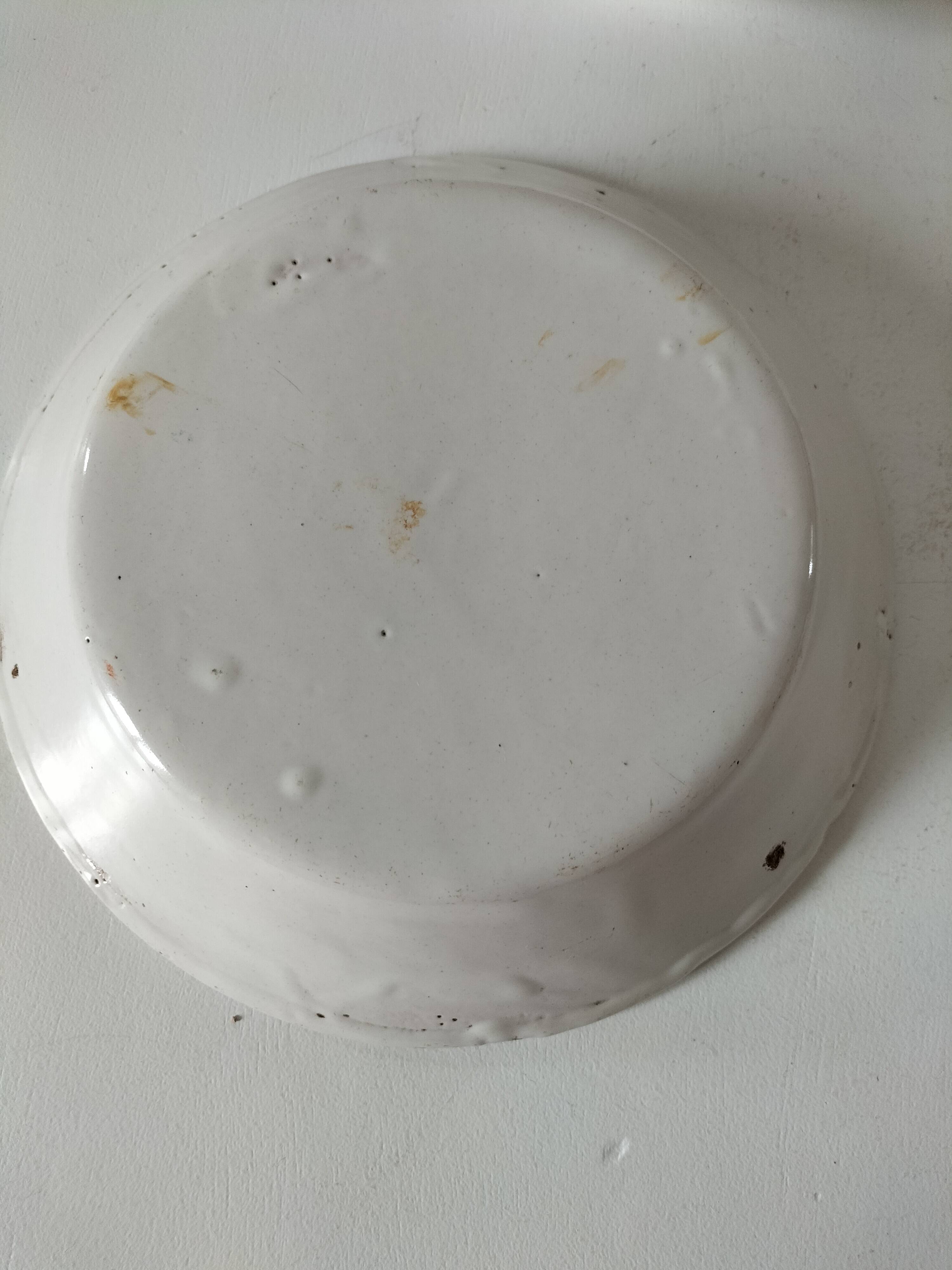 Pair of antique soup plates with hand-painted grape decoration