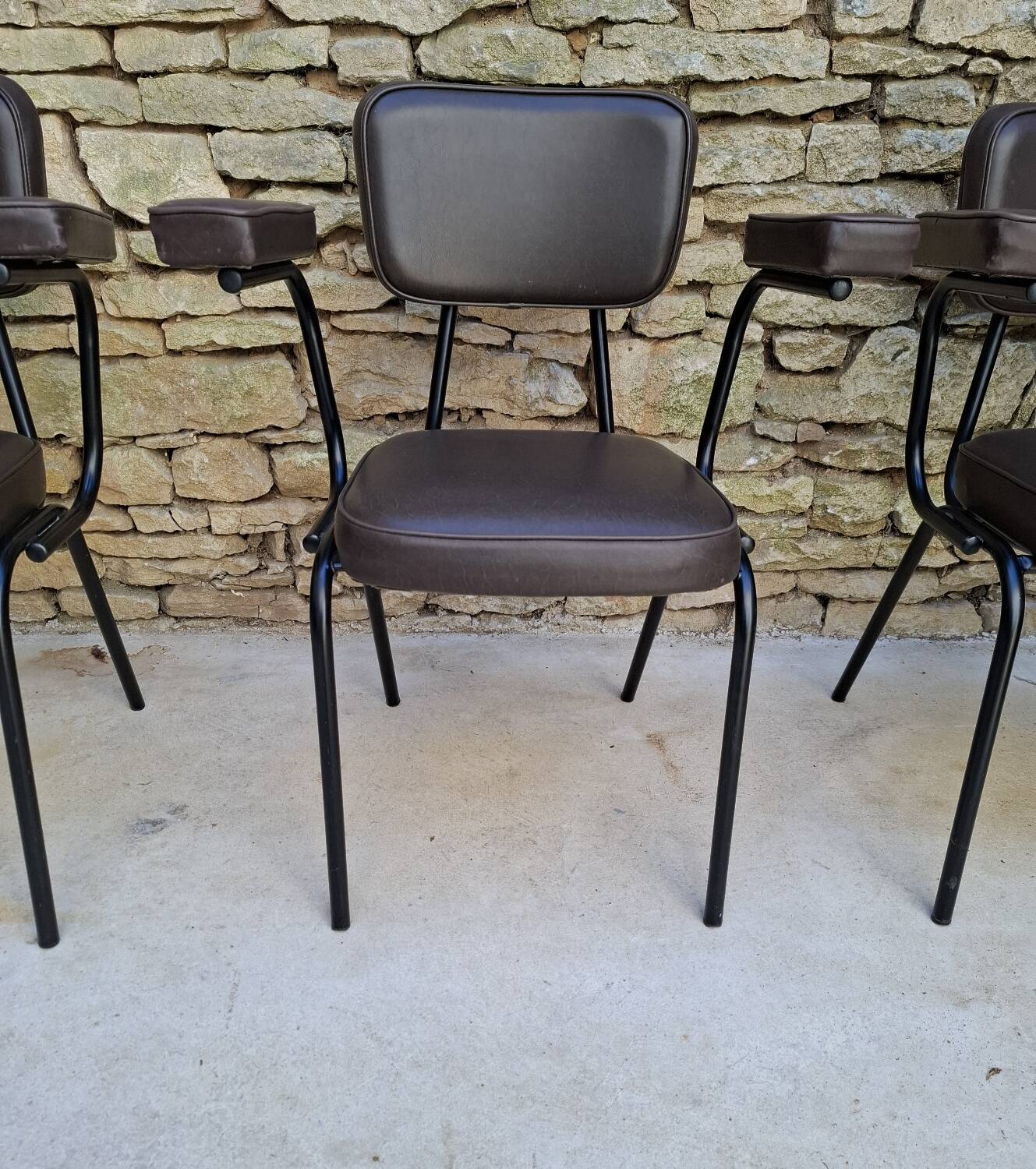 Brown faux leather armchairs