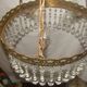 circular chandelier with a brass frame and crystal drops