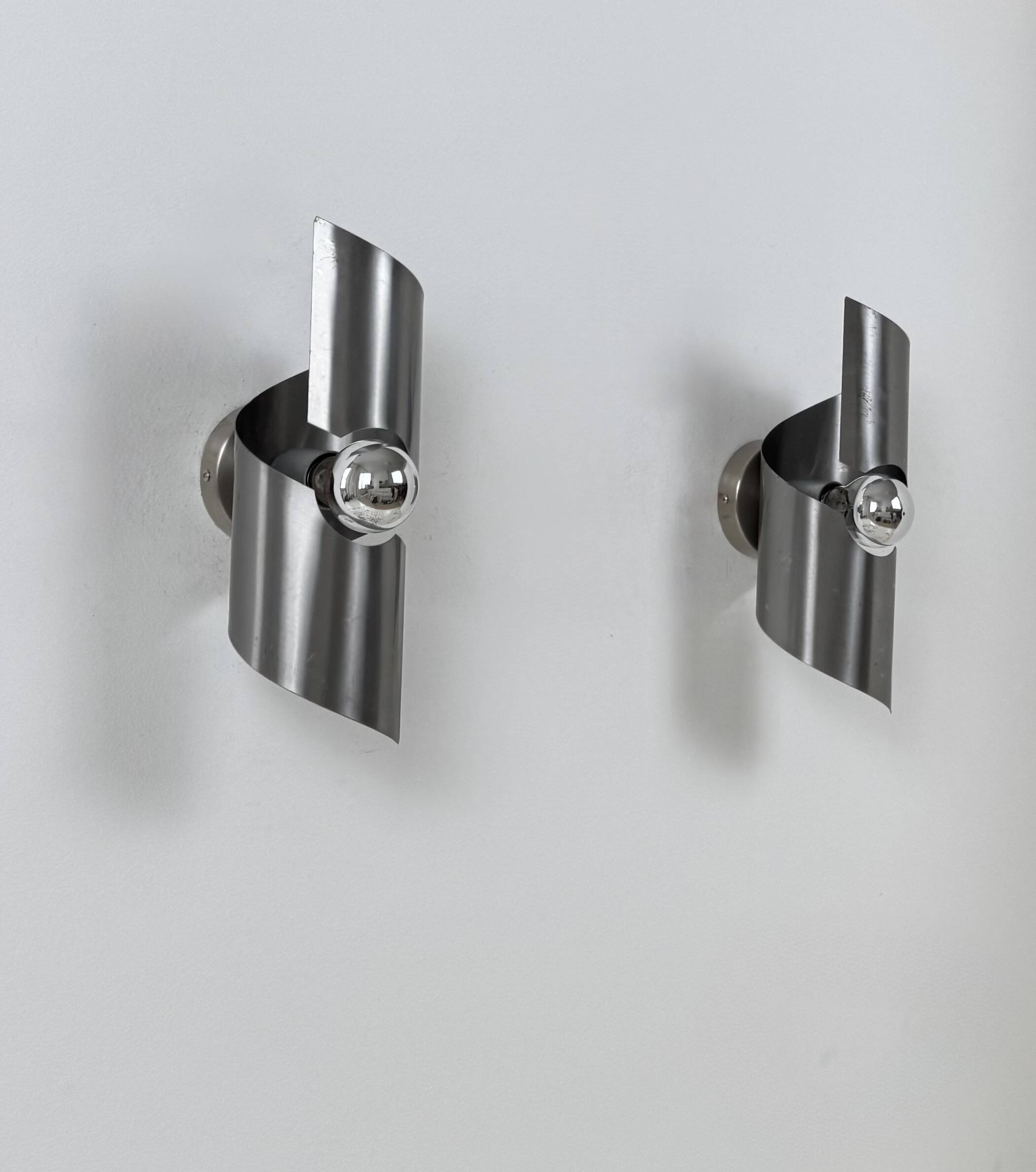 Pair of vintage wall lights, curved patinated steel, France, 1970.