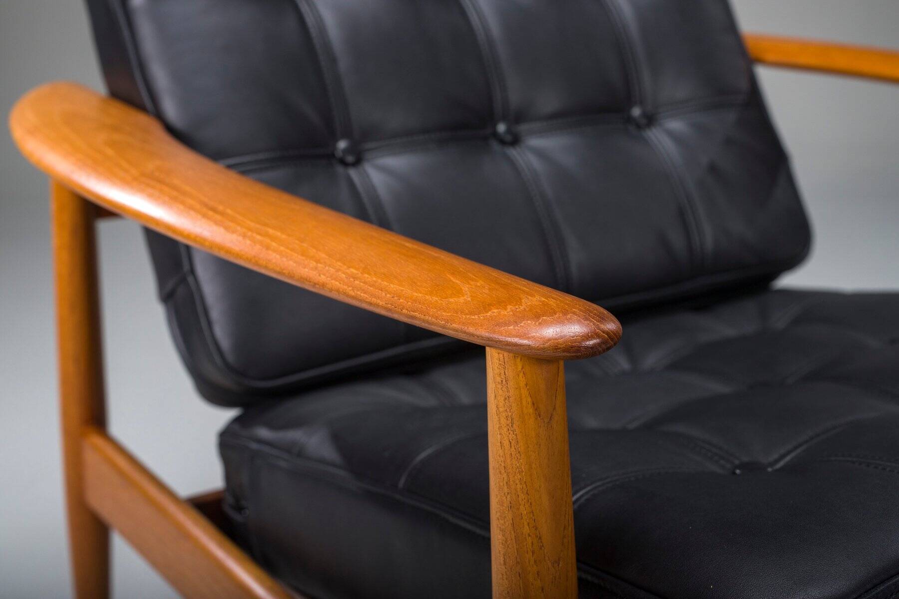 Armchair with Model FD 164 frame by Arne Vodder and Model 118 armrests by Grete Jalk in teak and black leather, Denmark, 1960s
