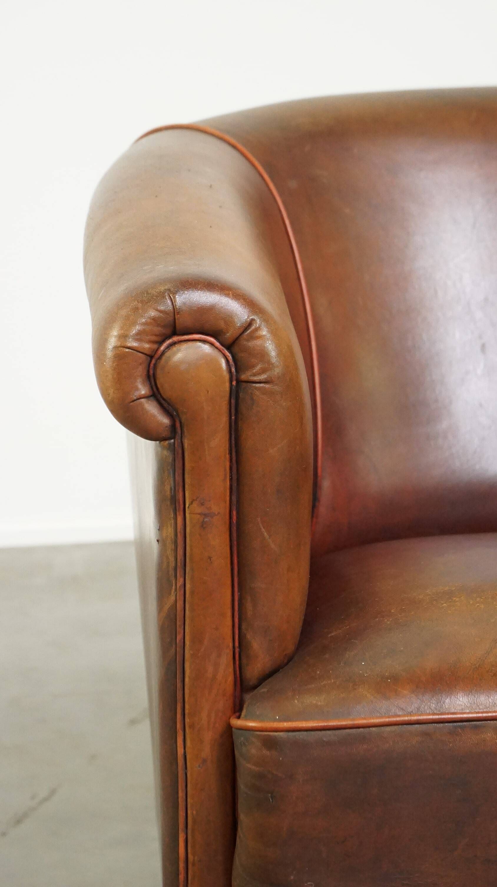 Neat, elegantly finished, cozy sheepskin club armchair with a fixed seat cushion