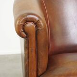 Neat, elegantly finished, cozy sheepskin club armchair with a fixed seat cushion