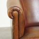 Neat, elegantly finished, cozy sheepskin club armchair with a fixed seat cushion