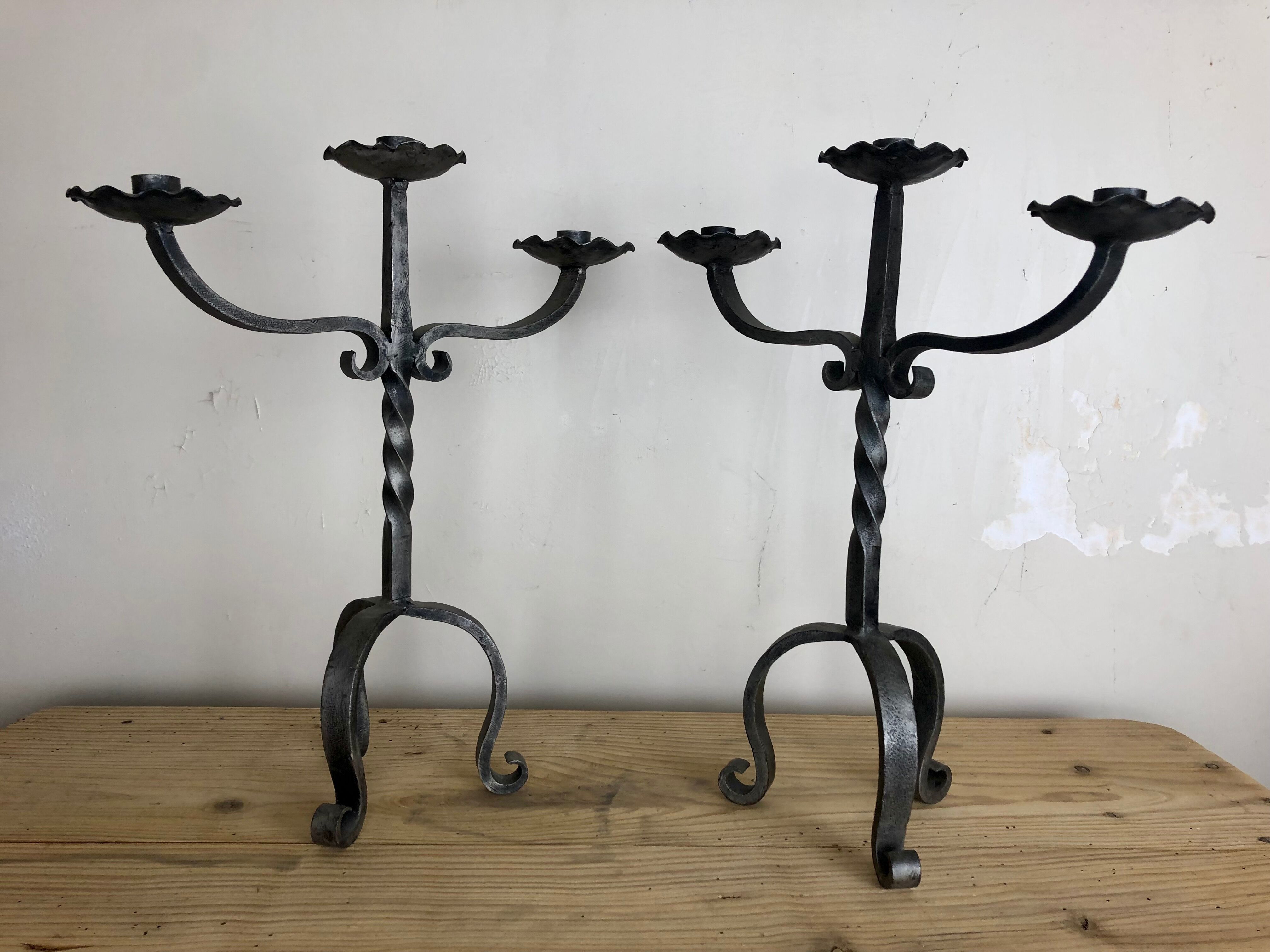 Pair of wrought iron candlesticks