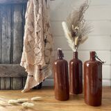 Old hot water bottles in glazed sandstone